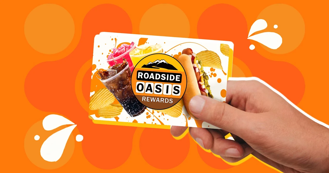 Driver holding a Roadside Oasis Rewards card in San Jacinto, CA